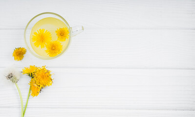 Dandelion tea in a transparent cup. Healthy herbal tea.