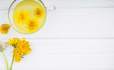 Dandelion tea in a transparent cup. Healthy herbal tea.