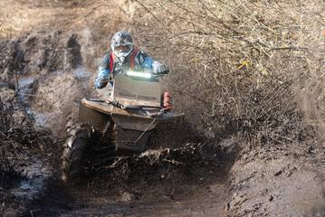 A powerful ATV epically overcomes off-road conditions.