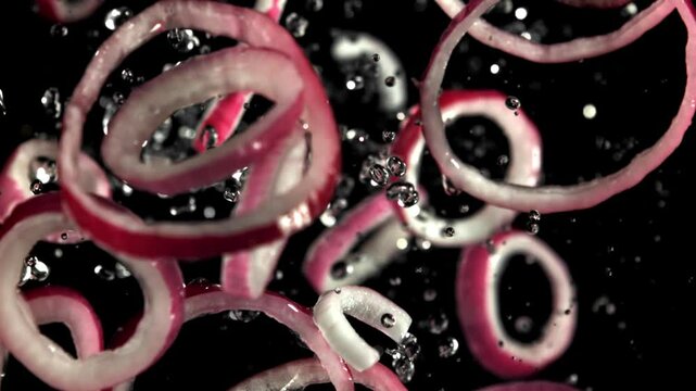 Sliced red onion rings fly up and fall down. Filmed on a high-speed camera at 1000 fps. High quality FullHD footage