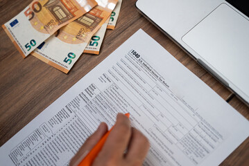 Male freelancer carefully examines strict requirements for filling Individual Income Tax Return...