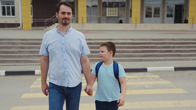 cross road zebra crossing, child crosswalk, School life begins, father encouraging son, holding hands crossing, childhood freedom, walking in confidence, teacher awaits inside, learning enthusiasm