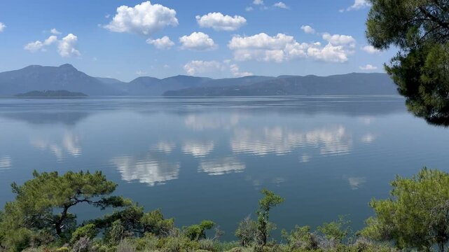 reflection of mountains and clouds on calm lake