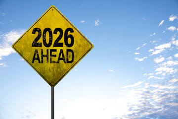 Naklejka premium 2026 new year. Night road leading to glowing 2026 sign, representing fresh beginnings, innovation, hope, and forward movement, surrounded by streetlights and atmospheric mist
