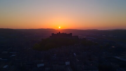 Sunrise over a medieval fortress city.