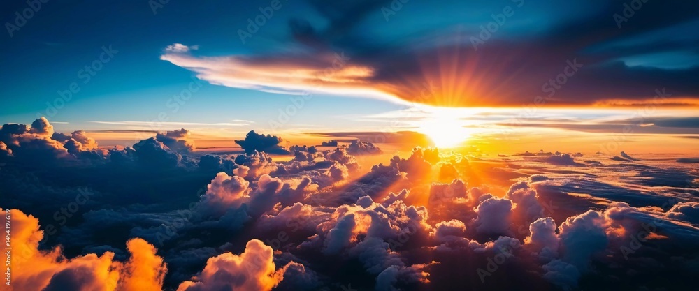 Poster golden rays cascade through fluffy clouds, creating a stunning display as the sun sets on the horizo