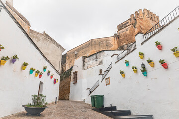 a cobbled street with typical white houses in Arcos de la Frontera, province of Cádiz, Andalusia, Spain