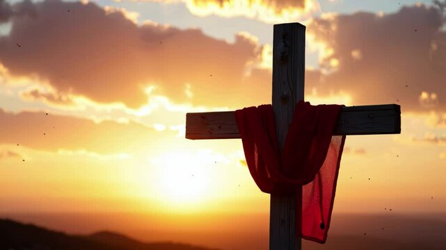 Wooden cross with red cloth against sunset sky. Christian religious symbol outdoors. Faith and spirituality concept for Easter and Good Friday celebration