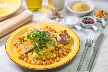grilled cod with couscous, chicken pea and baked garlic