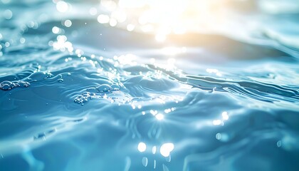 Sparkling blue water surface with sunlight reflections and air bubbles. Perfect for backgrounds, website banners, and screensavers.
