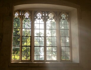 Sunlit Gothic window in an old building.  Peaceful, serene scene.