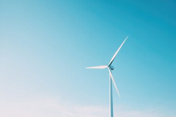 Fototapeta premium lone wind turbine standing tall against cloudless blue sky its blades catching gentle sunlight representing renewable