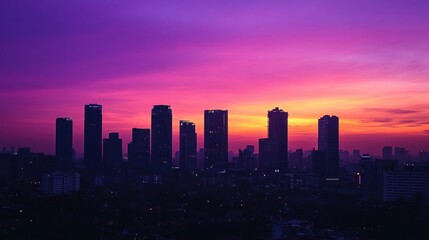 Silhouette of city skyline at vibrant sunset