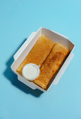 Boxed Blini with White Dip on Blue Background