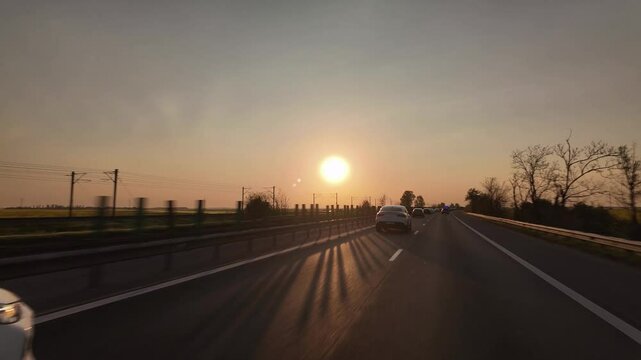 Early morning hyperlapse driving on A2 to Constanta with low sunrise over highway