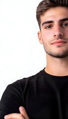 Fototapeta premium Close-up portrait of a young man with dark hair and a subtle smile, wearing a black shirt, against a white background