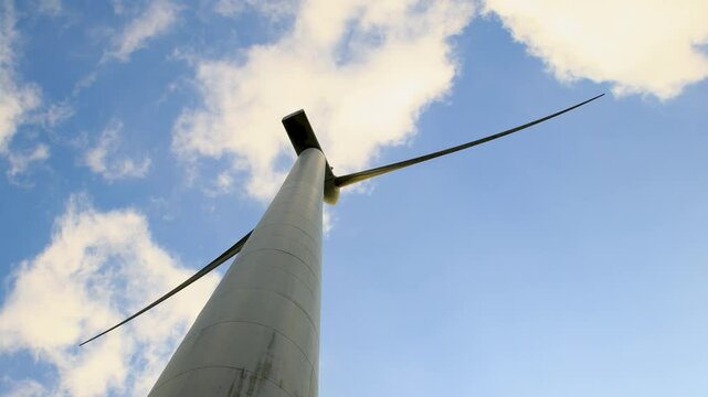 looking up the wind turbine spinning in the air, Netherlands