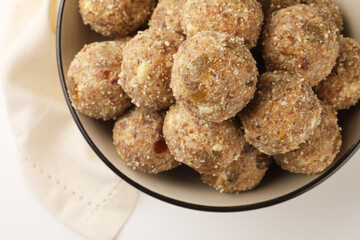 Healthy snacks, fitness lifestyle and high fiber diet concept with dates and dryfruits energy Laddus or Ladoo surrounded by dried fruits, Cashew Nuts, pistachios , almonds