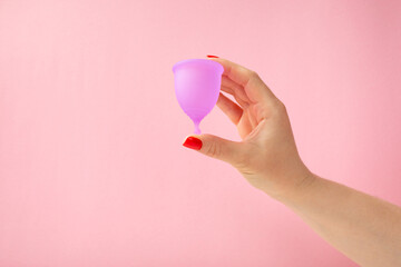 Menstrual cup on a bright background. Sanitary napkins, tampons and menstrual cup.Concept of...