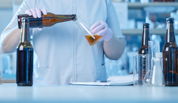 Scientist measuring beer quality in laboratory setting of brewery factory