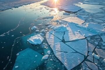 Sunrise Over Melting Icebergs in Arctic Ocean Waters with Reflective Ice Fragments