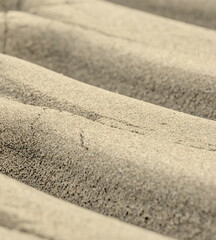 A sandy surface with a few small cracks