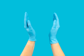 Medical nitrile gloves,blue cap, disposable medical mask on textured background. Medic protective clothing. Surgical latex gloves. Rubber gloves manufacturing.Medicine concept. Top view. Copy text