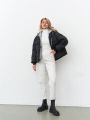 Model displays modern fashion in a stylish studio during a photoshoot