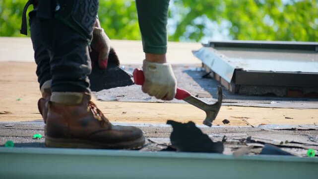 Roofer remover old roof covering. before installing a new roof on an house. Work elements