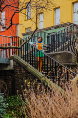 An attractive female is posing on the steps that lead to the Chester Beatty Library, a famous...