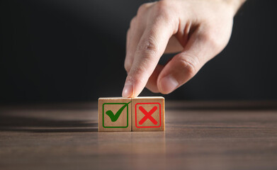 Businessman is thinking and making choices right from wrong symbols. Decide to vote accept or not. Yes or No decisions, business options in difficult situations. True False, crisis decision making.