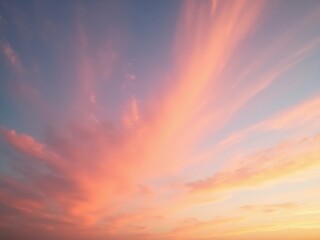 Fototapeta premium Panoramic sunset sky with pink, orange, and purple clouds blending into soft yellows and blues, capturing a serene, colorful moment just after sunset.