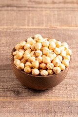 Organic hazelnuts in a wooden bowl. Vegan food concept. 