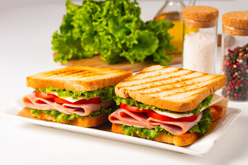 Club sandwich with ham, cheese, tomato and lettuce