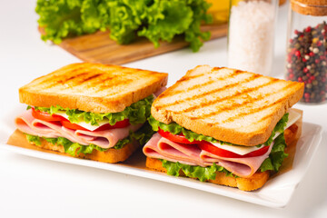 Club sandwich with ham, cheese, tomato and lettuce