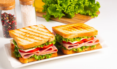 Club sandwich with ham, cheese, tomato and lettuce