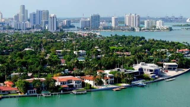 Miami luxury mansions Sunset Islands. Aerial 4k drone video showing waterfront multimillion dollar homes with docks and views of downtown miami in background