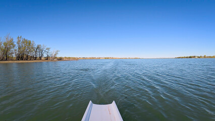 springtime rowing on lake in Colorado - POV rower perspective