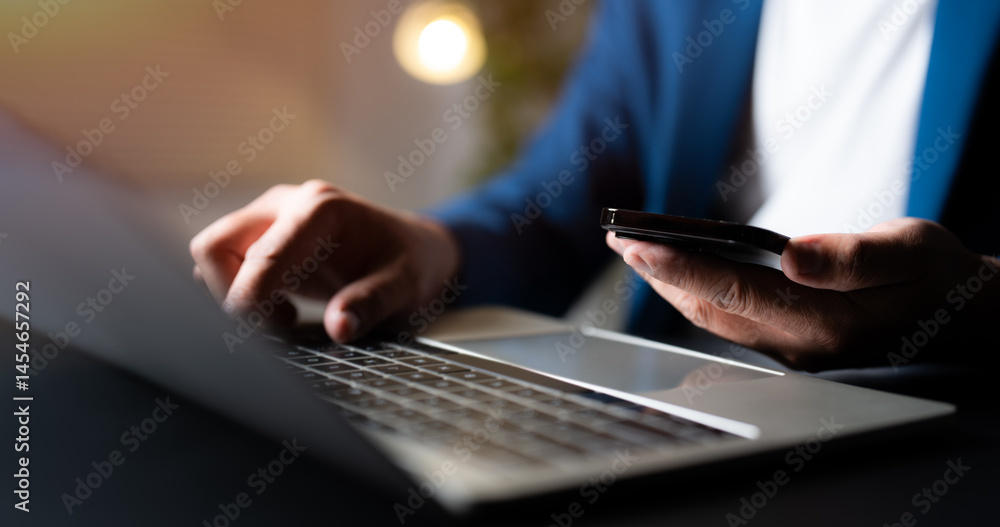 Poster business man using and typing keyboard of laptop computer on office desk with mobile smartphone comm