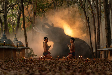 Muay Thai Fighters Performing Wai Kru Ritual in Forest with Elephant. Traditional Martial Arts...