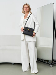 Elegant model showcasing modern fashion in a sophisticated studio setting