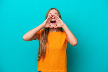 Young Russian woman isolated on blue background shouting and announcing something