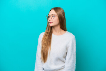 Fototapeta premium Young Russian woman isolated on blue background looking to the side