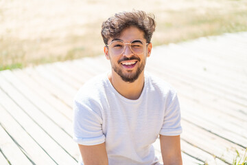 Handsome Arab man at outdoors With glasses and happy expression