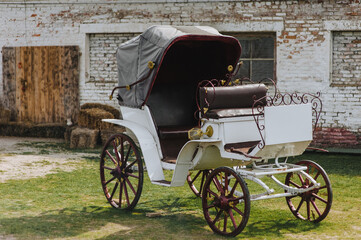 Photo of a vintage antique carriage in a rural ranch setting.
