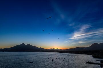 Sunset at La Isleta del Moro with Los Frailes volcanoes seen at left