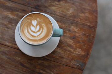 Hot latte coffee on wood background