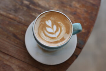 Hot latte coffee on wood background