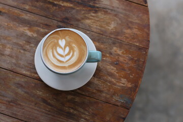 Hot latte coffee on wood background