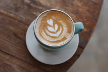 Hot latte coffee on wood background